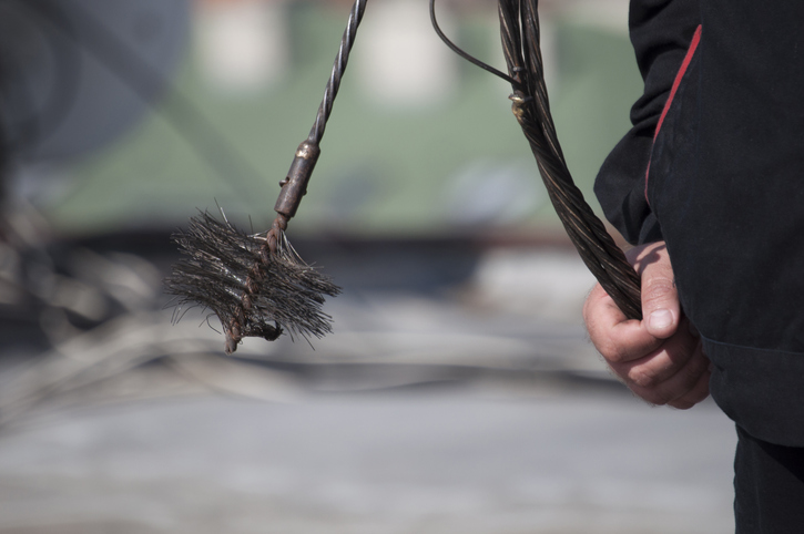 Chimney sweep Chimney sweep at work, Close up of the hand holding a chain with the broom to clean the chimney